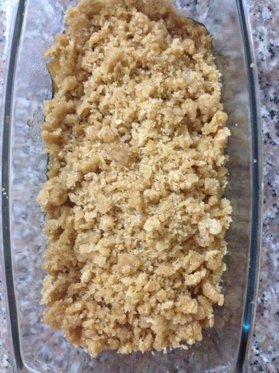 Put the apples in a small baking dish and cover them with the crumble topping, without pressing down