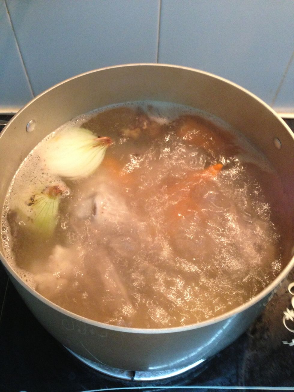 Put the aromatics and carrot ( for the sweetness) all in the broth. Add a table spoon of seasoning. Let the thing boil for a good 45 min. Put in the chicken thigh at ~ 30 min.