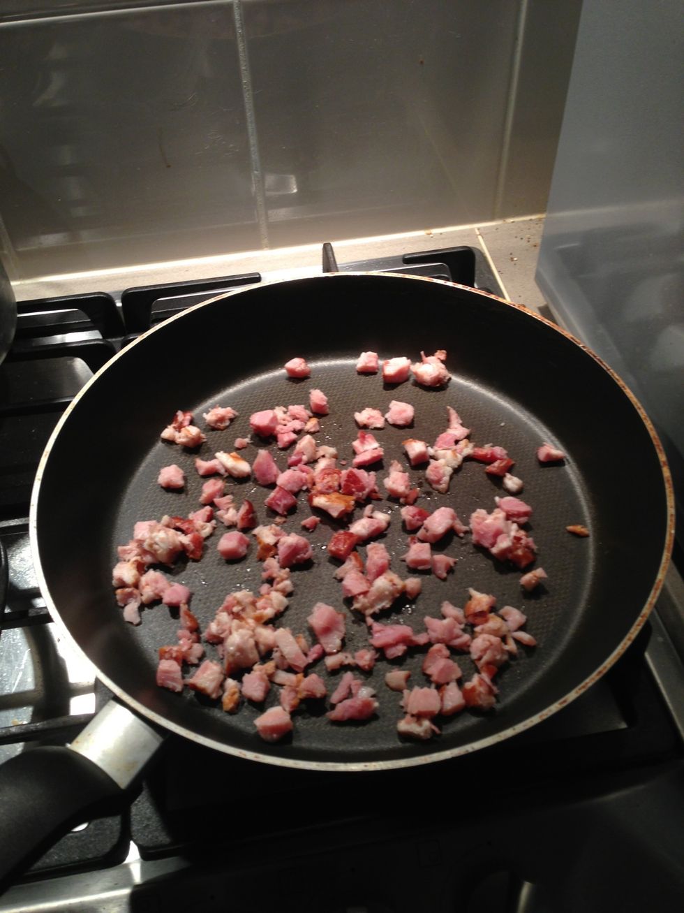 Put the bacon pieces or diced bacon in the fry pan