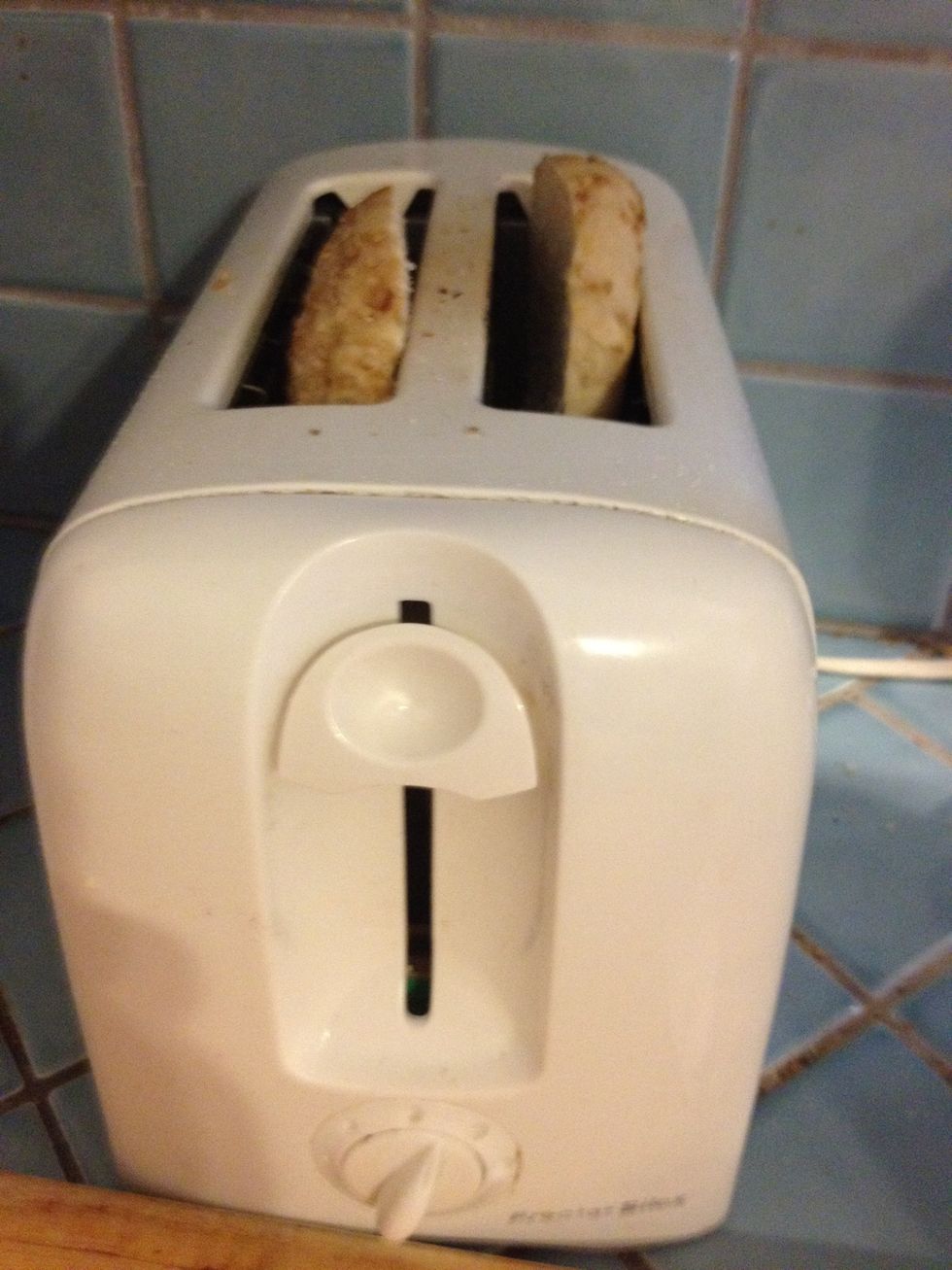 Put the bagel in the toaster. You can also use a toaster oven.