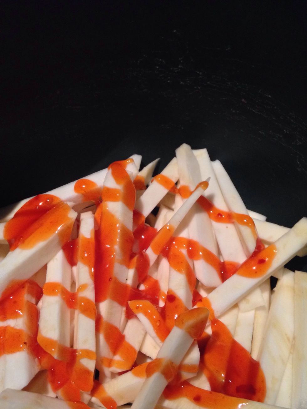 Put the batons in a bowl and drizzle with sweet chilli, olive oil, salt and pepper, toss to coat. Place in an oven dish sprayed with non stick spray and bake at 180 deg Celsius for about 30 min.