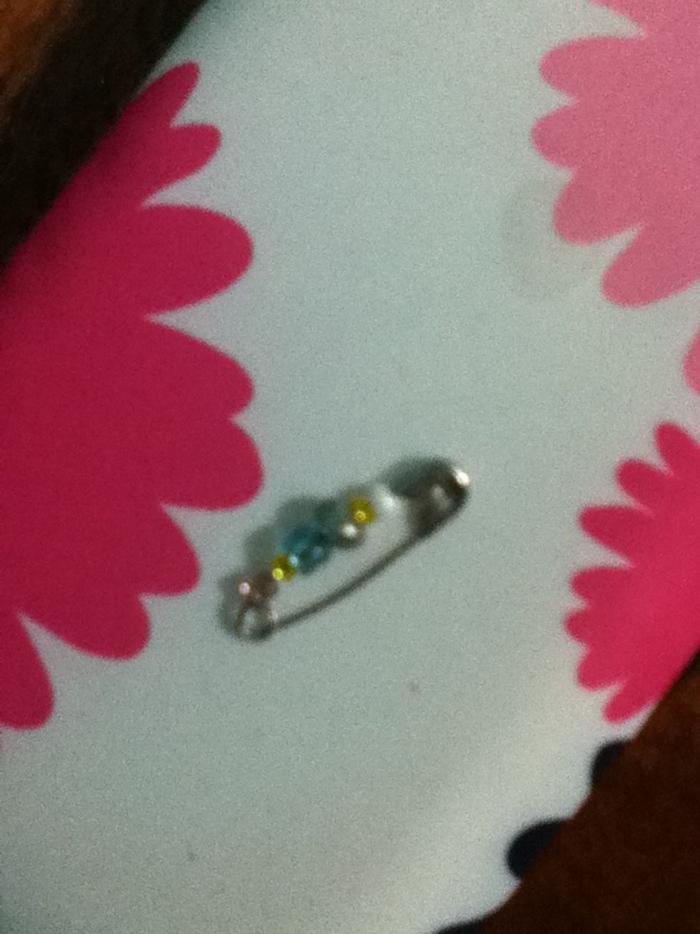 Put the beads on the pin and close it