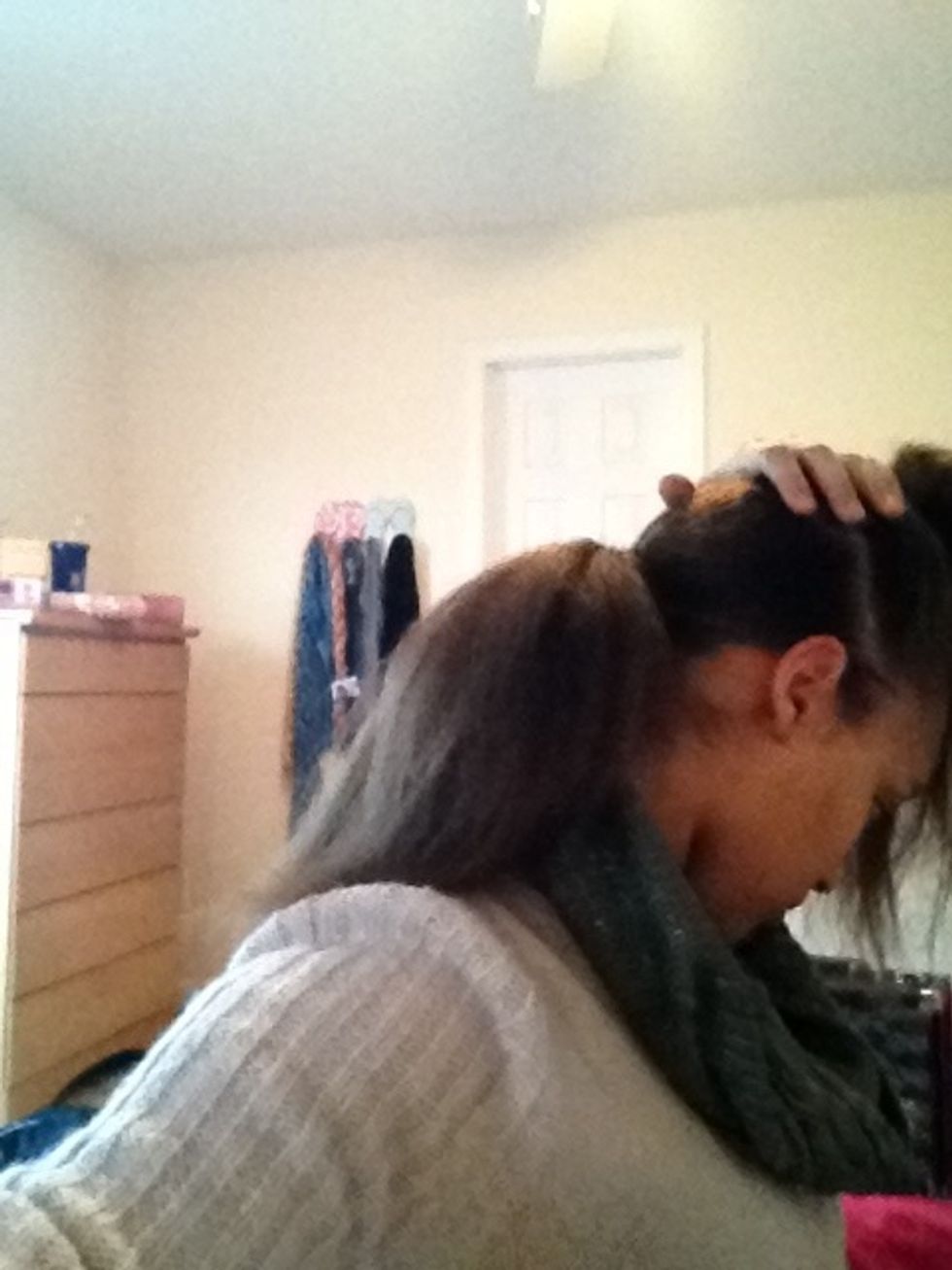 Put the bottom half into a low ponytail. My hair is really thick, so I don't need to tease it, but if yours is thinner I'd suggest teasing it.