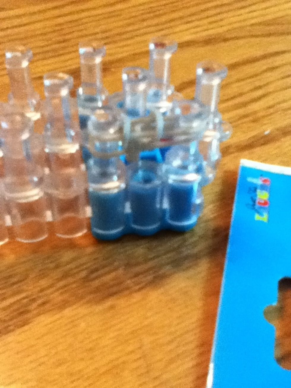 Put the bottom rubber band on top of the top rubber band