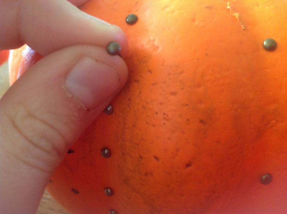 Put the brads in the lines of the pumpkin.