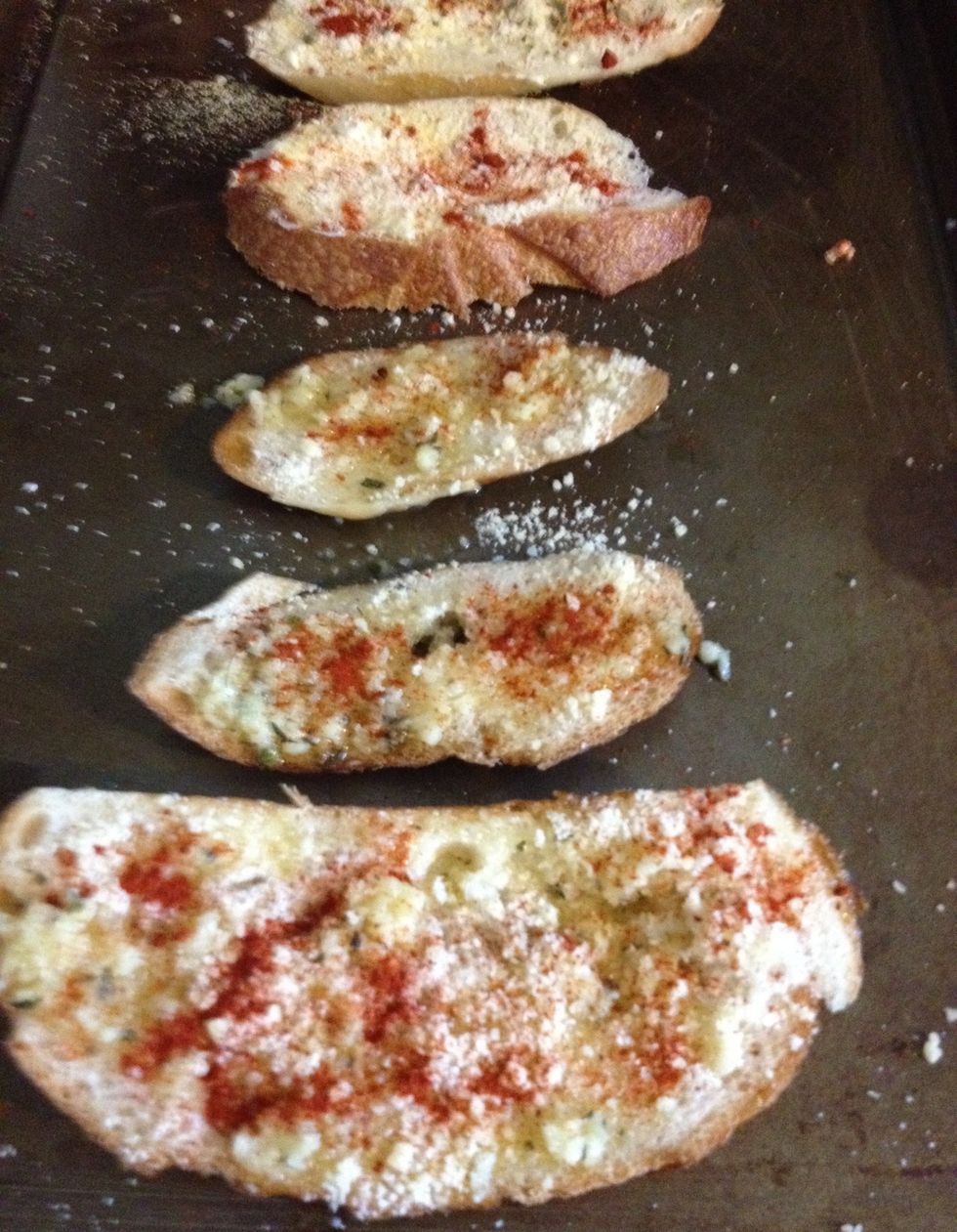 Put the bread into the oven for about 10 to 15 minutes, until the cheese has melted and they are golden brown.