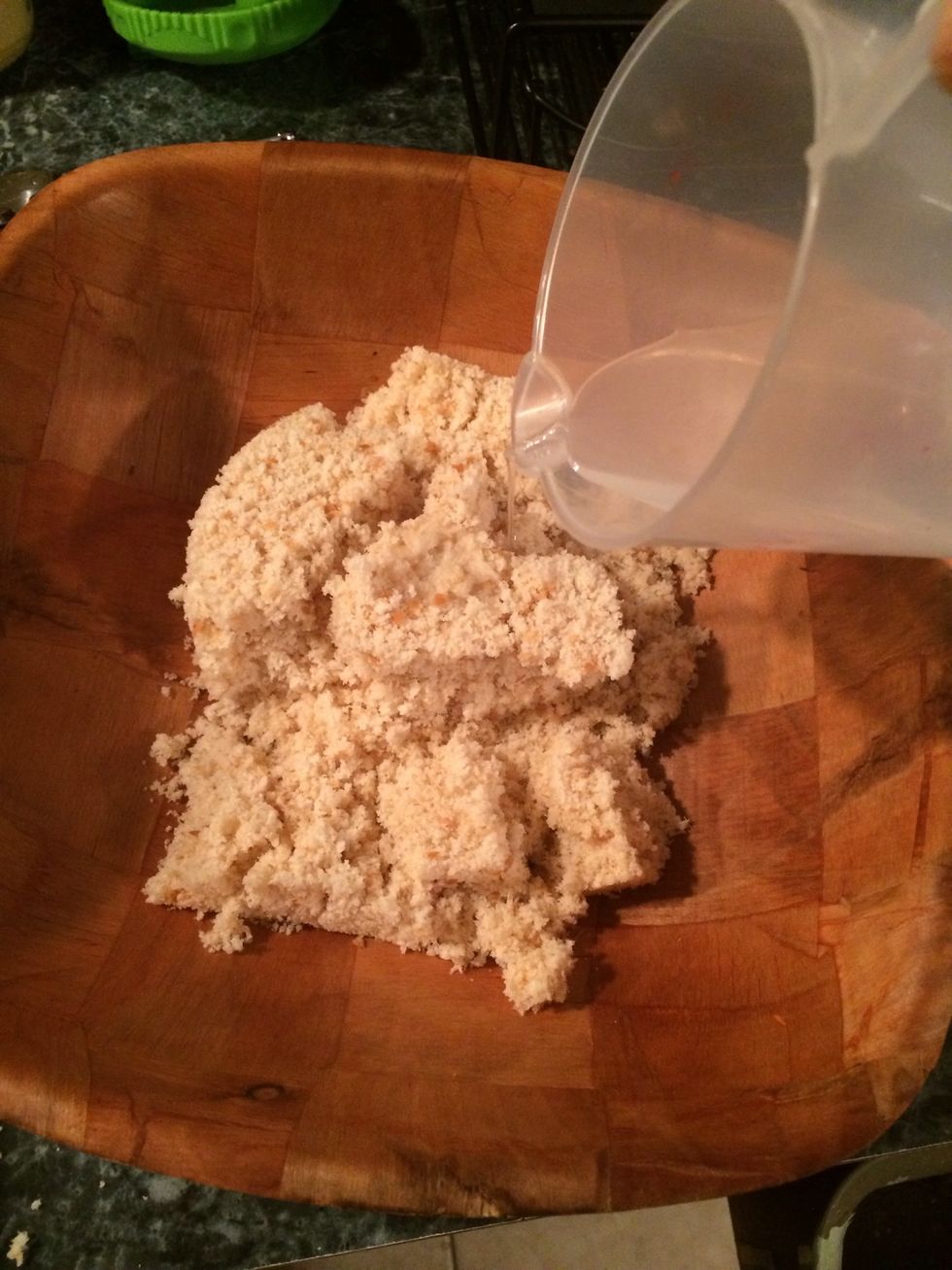 Put the breadcrumbs in a bowl. It will look like a lot(2 cups to be exact) Once blended it will disappear into the beef. To the crumbs add a little more than a 1/4 cup of water or milk. Let it soak.