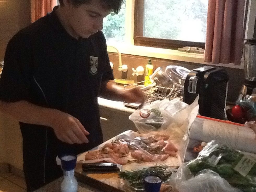 Put the breasts on some baking paper and add some rosemary.