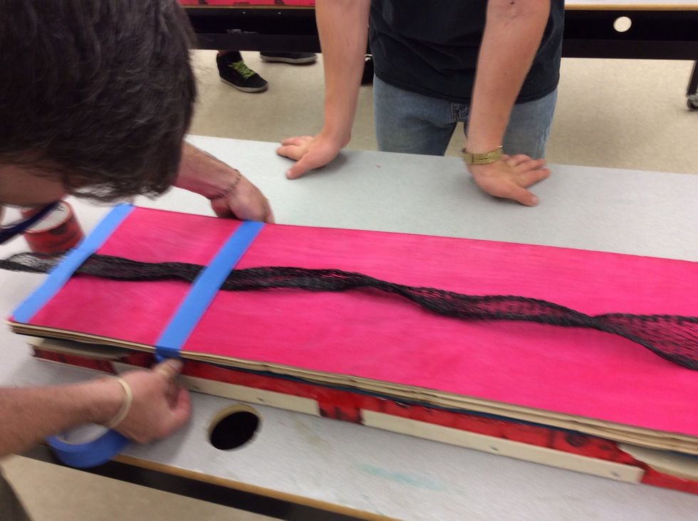 Put the breathing strip across the centre of the board and tape each end so it doesn't move.