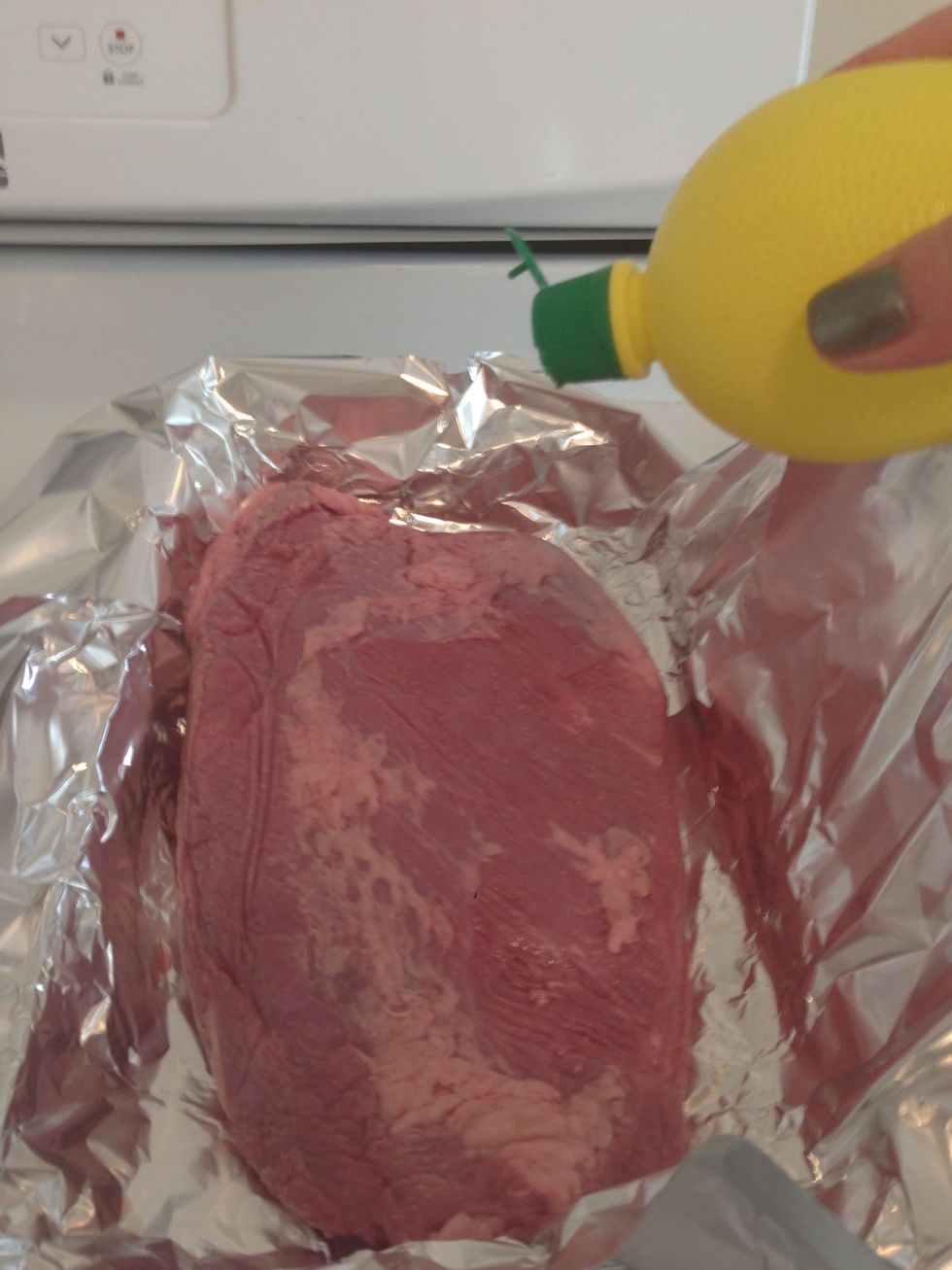 Put the brisket in a large pan and pour 1 tsp of lemon juice on top of the brisket. You want the fat side down at this point because you will coat the other side.