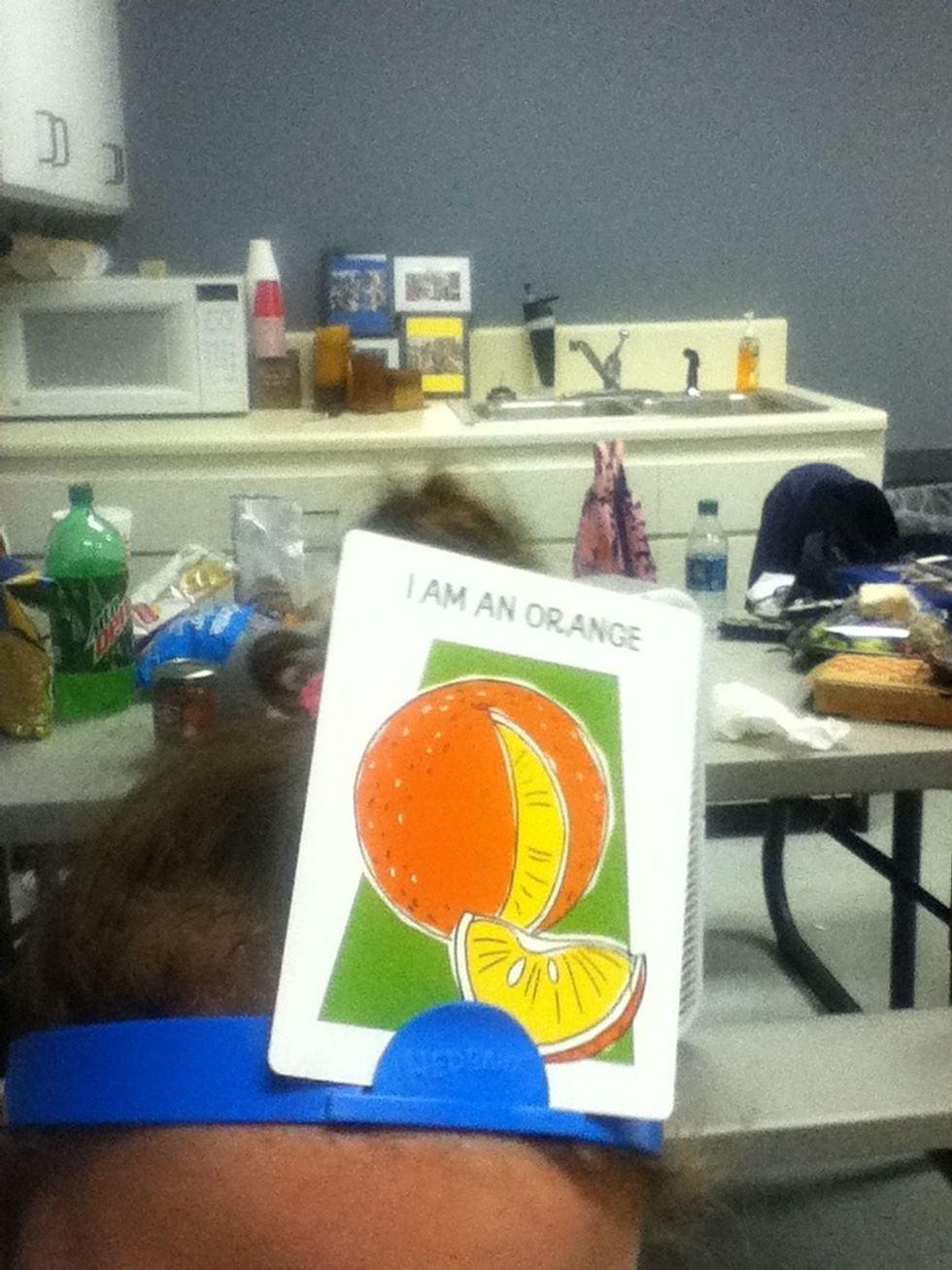 Put the card on your hedban  AND DON'T LOOK AT THE CARD