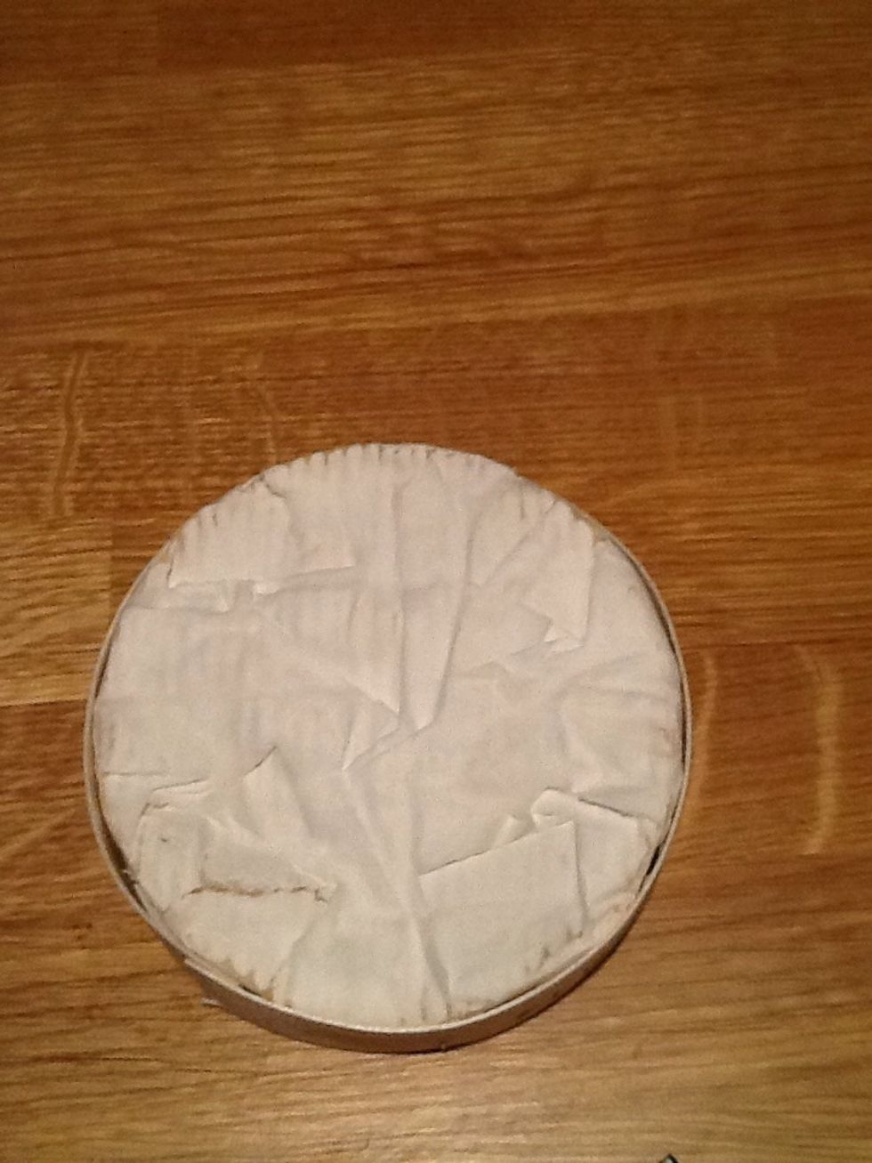 Put the cheese back together and in the box. If your box is made of plastic or cardboard out it in an oven proof dish instead. Bake it in the preheated oven for 10 mins or until the centre is melty