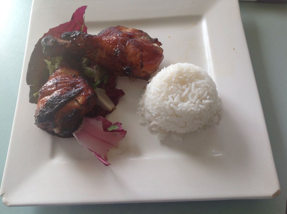 Put the chicken drumsticks on a plane with the optional salad and rice.