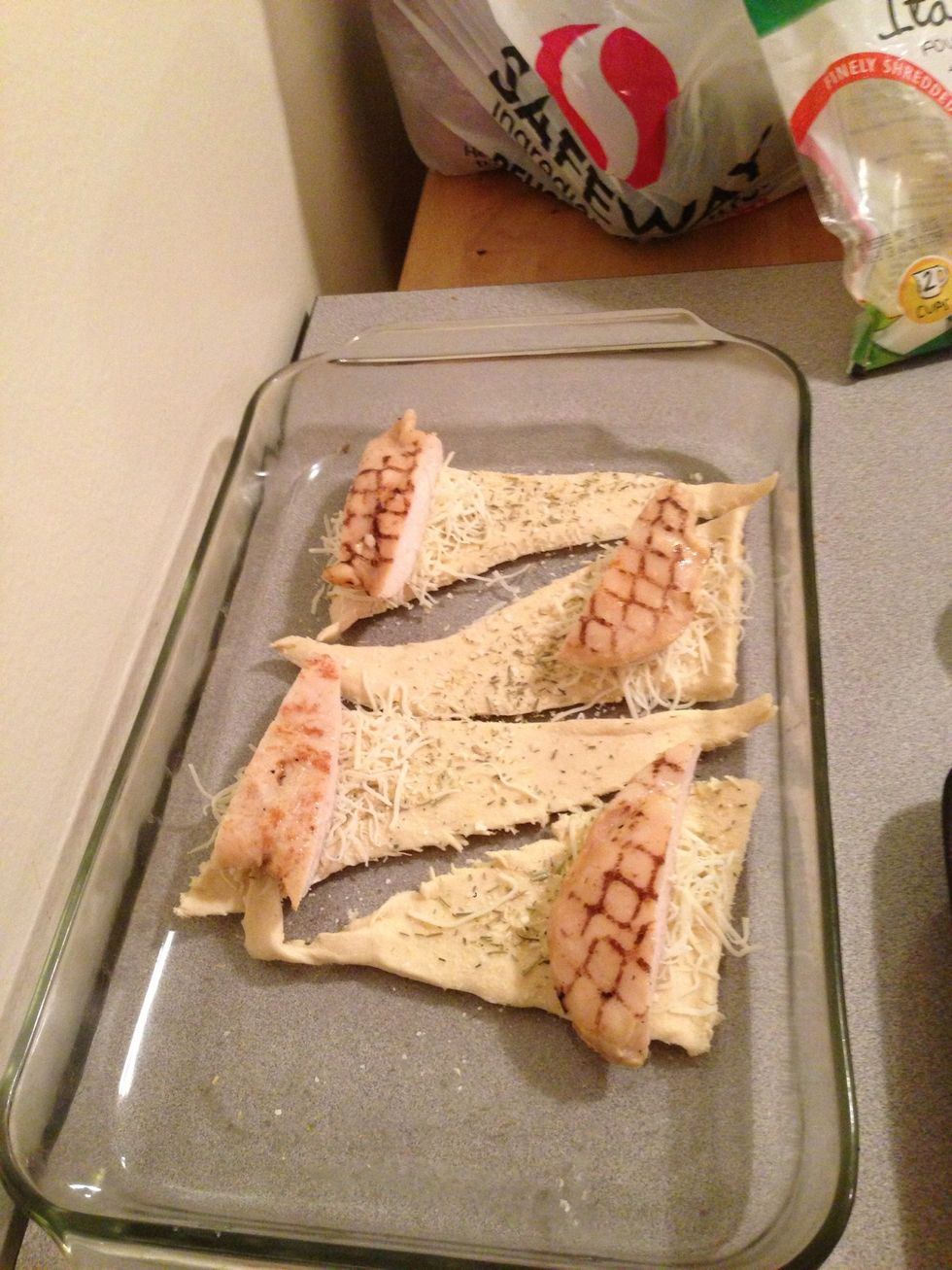 Put the chicken slices on the big side of the crescent roll.