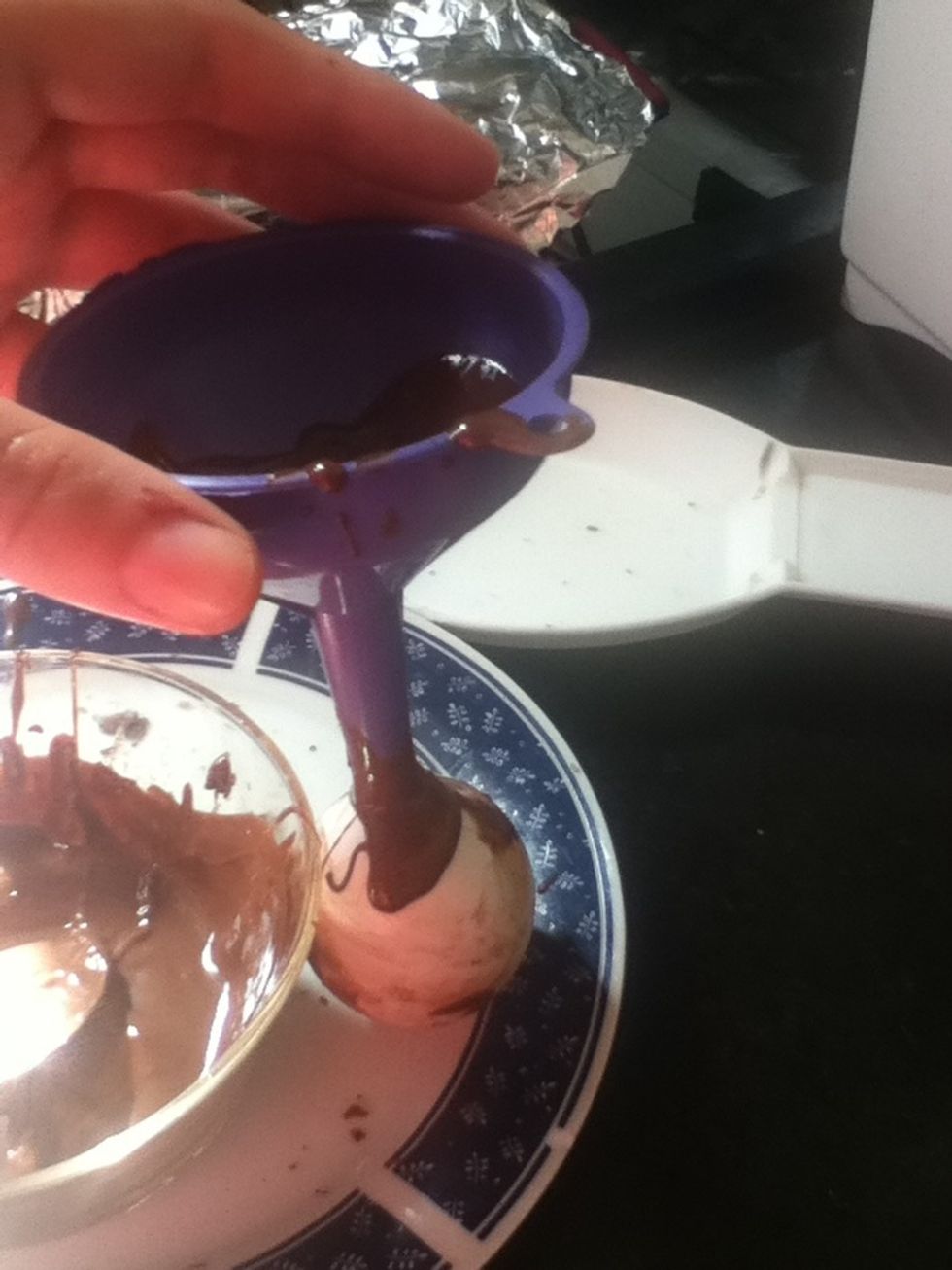 Put the chocolate in the egg with the help of a funnel .