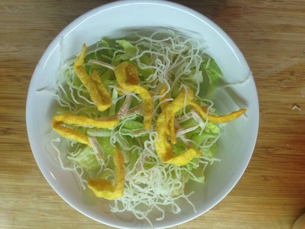 Put the chopped lettuce, celery, shredded chicken, maifun, and won ton in a bowl. Here is the finished salad. Next mix in a dressing. To learn how to make a homemade dressing, continue this Snapguide.