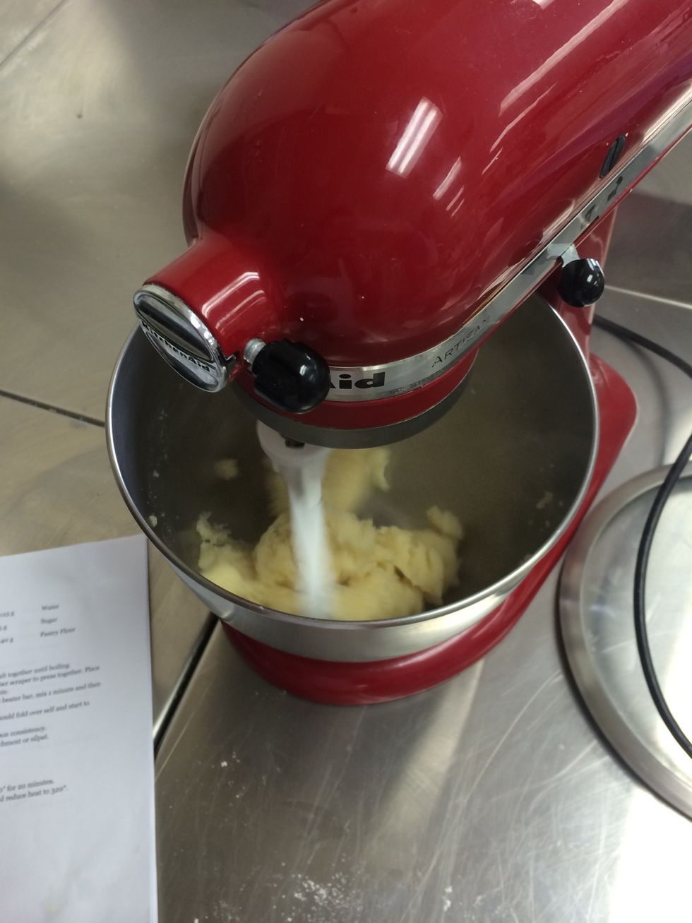 Put the cooked mixture in a mixing bowl with a flat beater bar and mix for one minute
