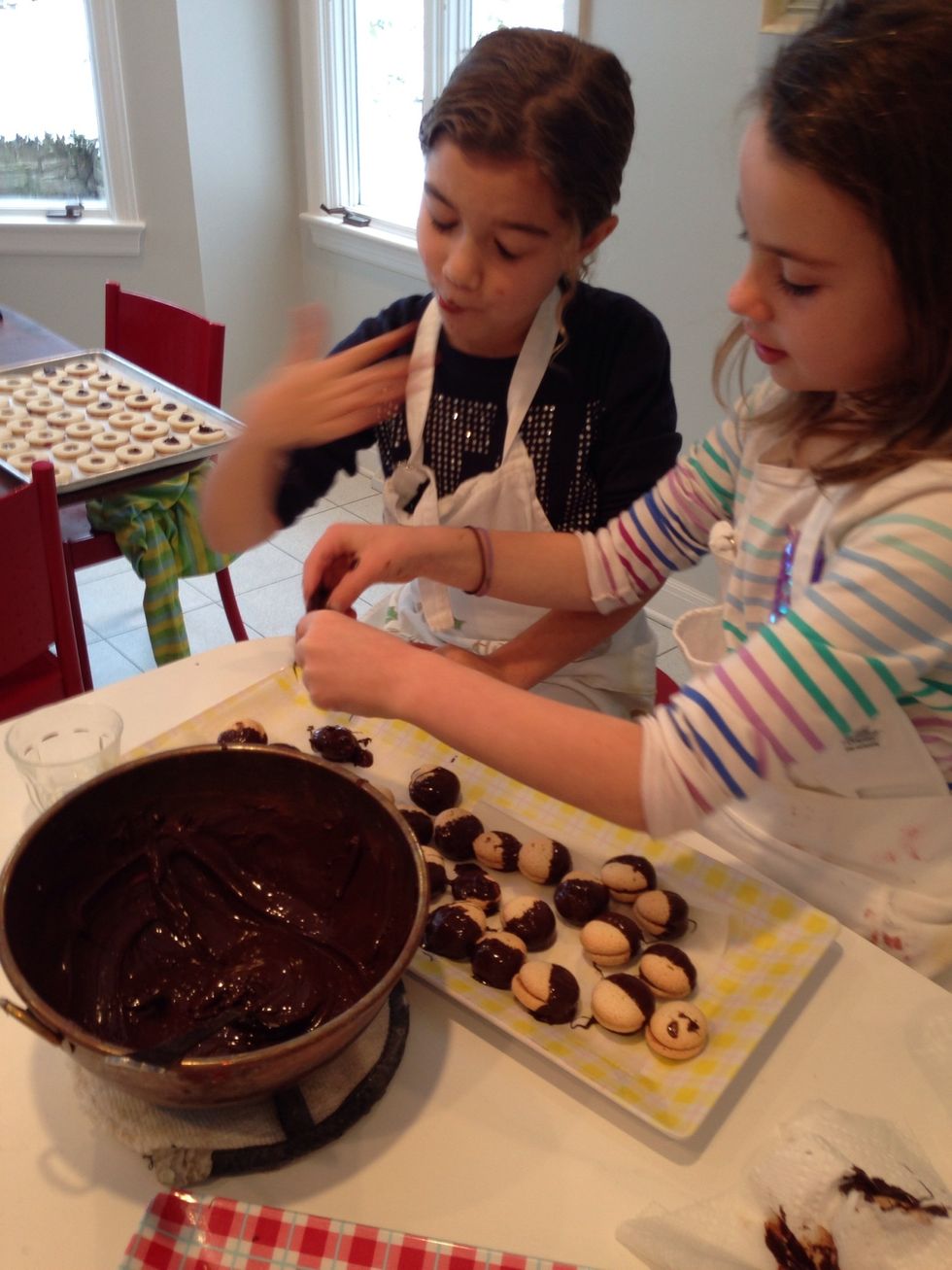 Put the cookies on waxed paper to set. They will be shiny when the choc gets hard because of tempering. Be sure to tell your friends you can temper choc. They will worship you. As they should.