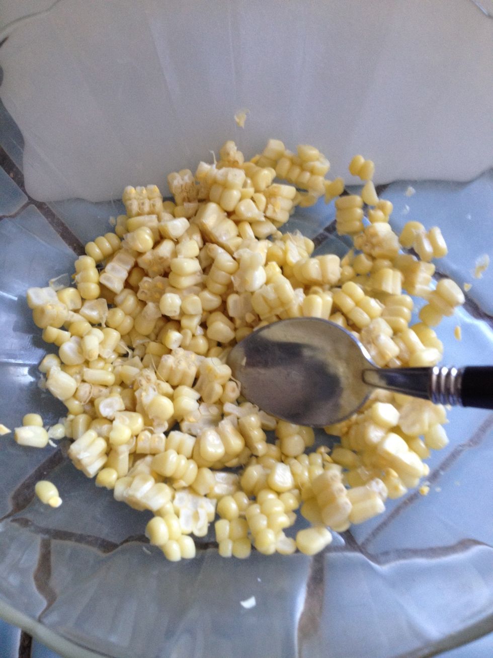 Put the corn in a bowl and break up the individual kernels.