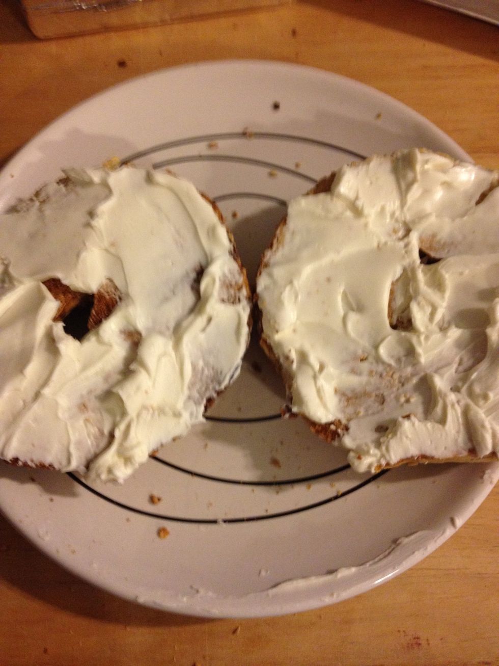 Put the cream cheese on both the bagel halves.