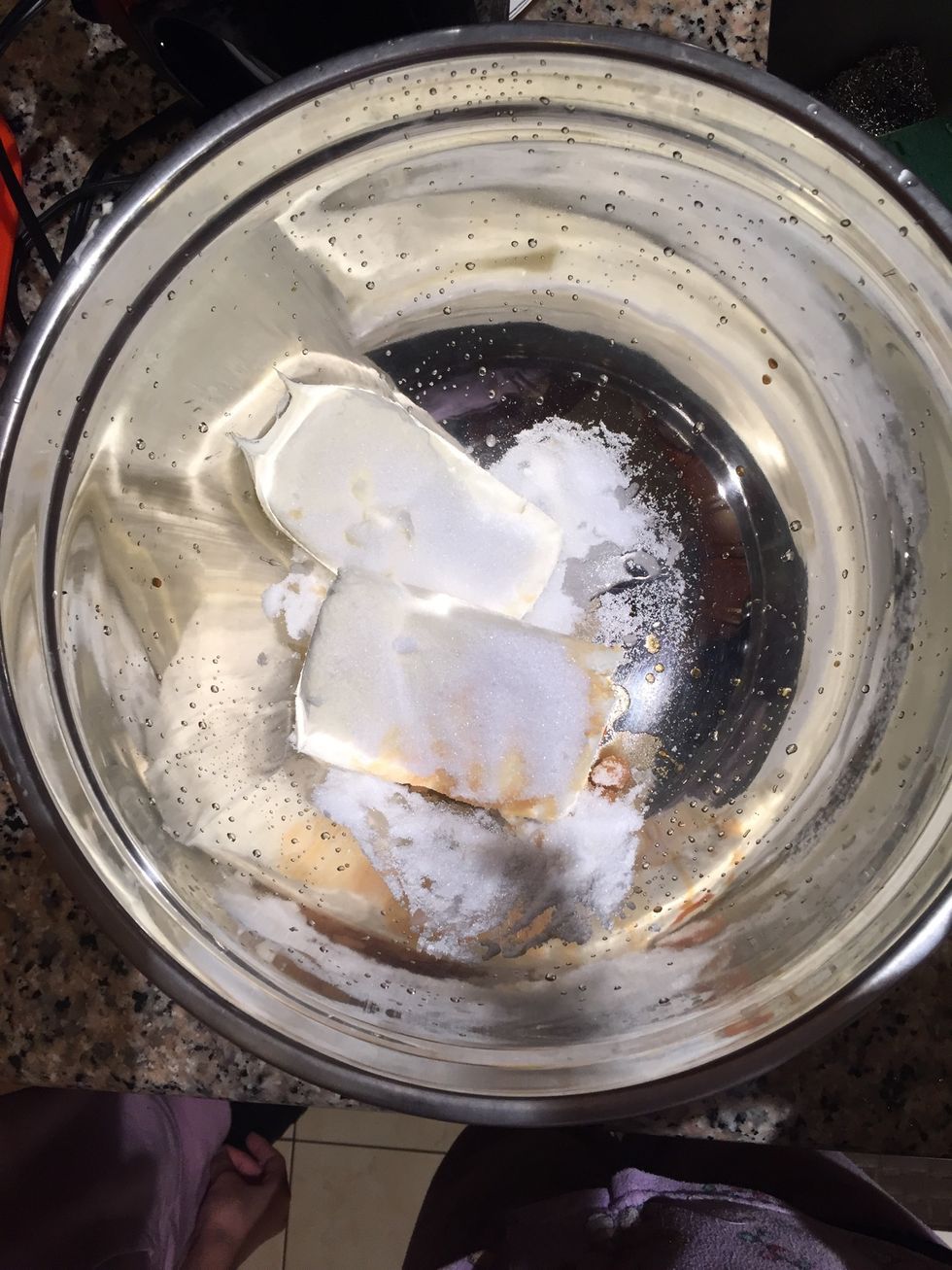 Put the cream cheese, vanilla extract, & sugar in a large bowl and mix on low speed. Be careful not to over mix because it makes the mixture have a grainy texture, causing the cheesecake to separate