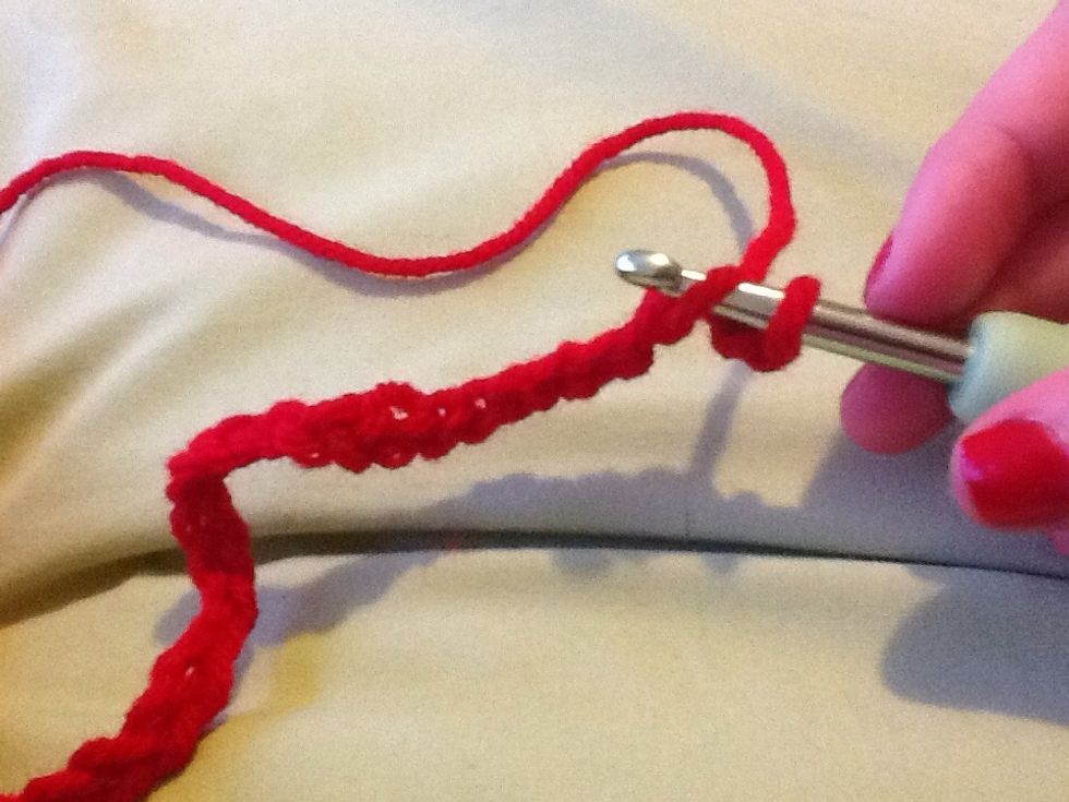 Put the crochet hook through the second hole in the chain