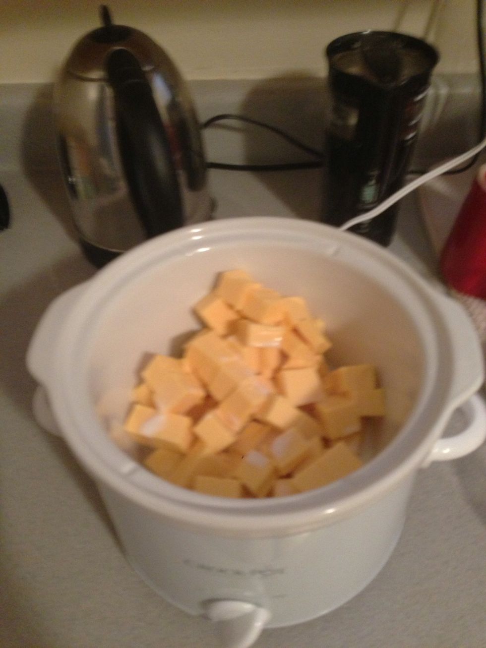 Put the crock pot on high heat. Add the milk and cheese to a crock pot.