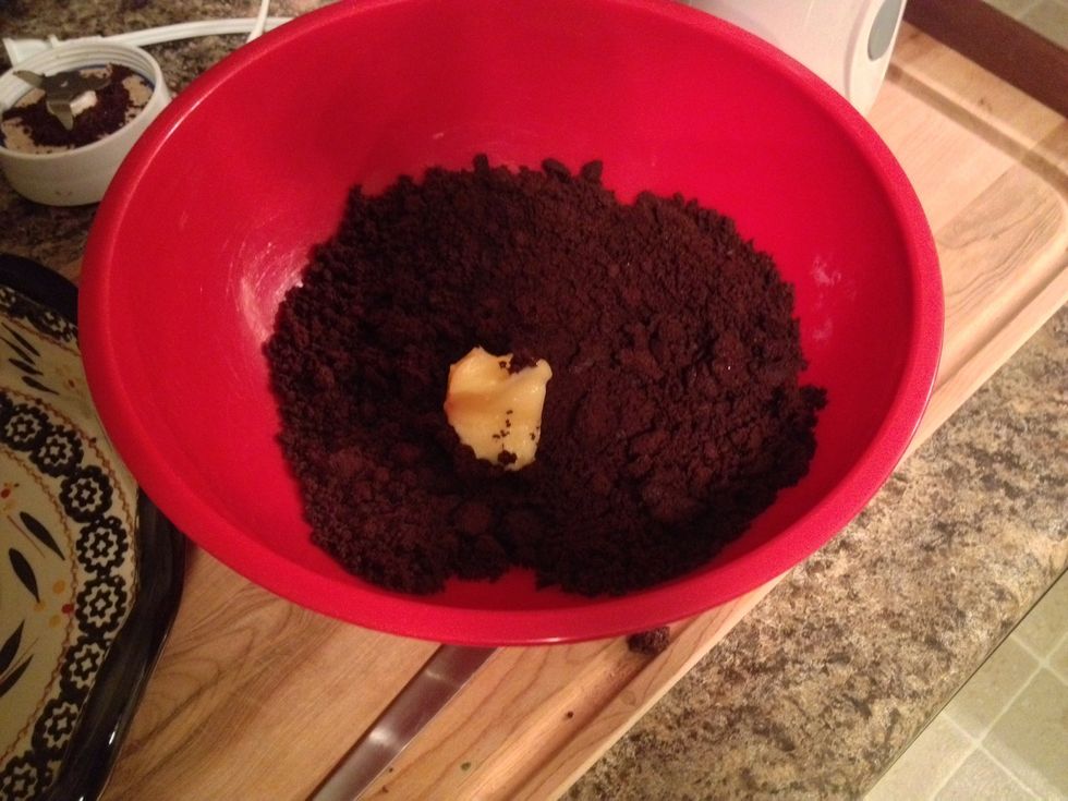 Put the crumbs into a bowl with about a tablespoon of room temperature butter.
