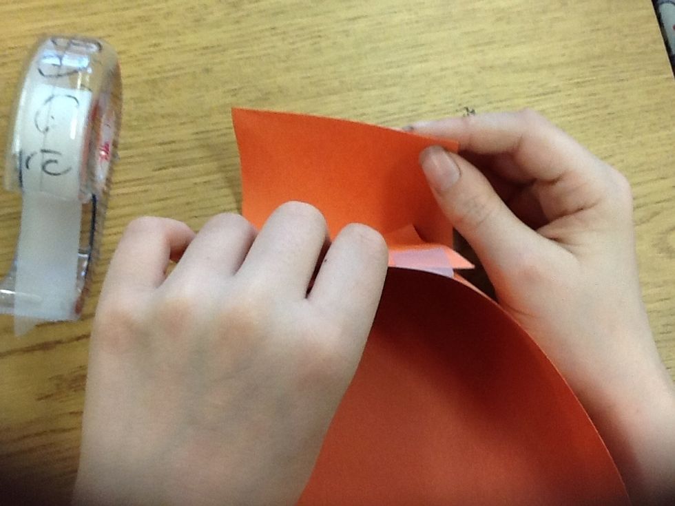 Put the cuts on one side together and then tape them.Do the same with the other side. NOW IT SHOULD LOOK LIKE A BASKET !
