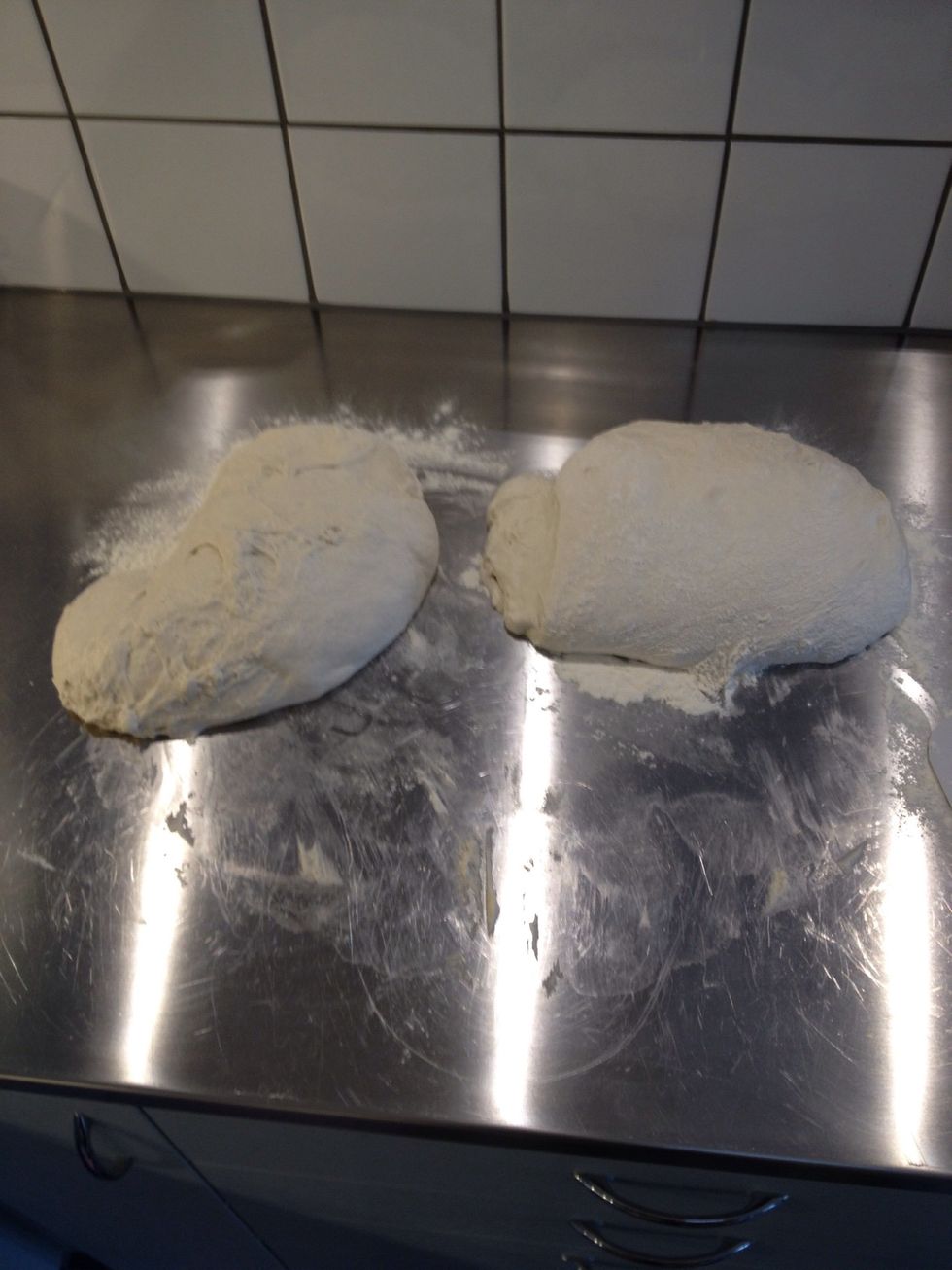 Put the dough on a floured surface and divide it in two. Now gently fold the long sides towards the middle to form a loaf. (Weird lighting from above adds an up-lifting special effect.)