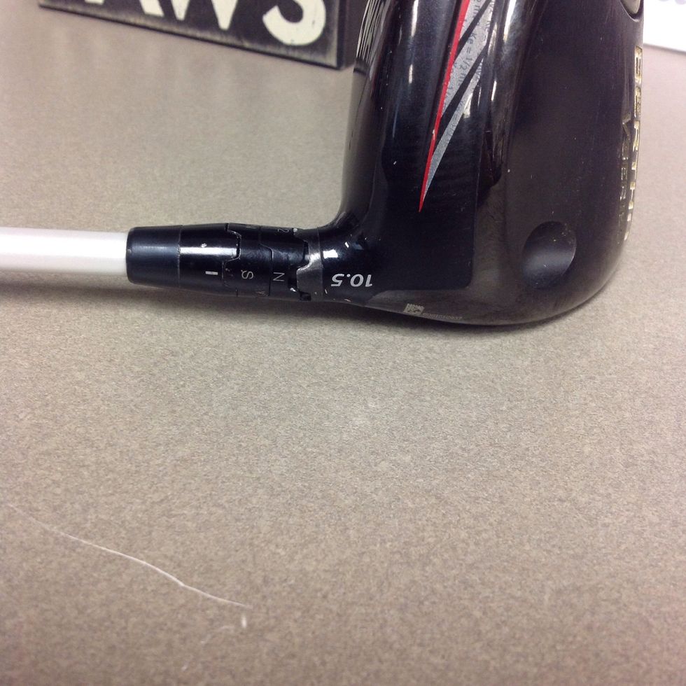 Put the driver head back onto the shaft with the bottom line lined up with the back of the driver head.