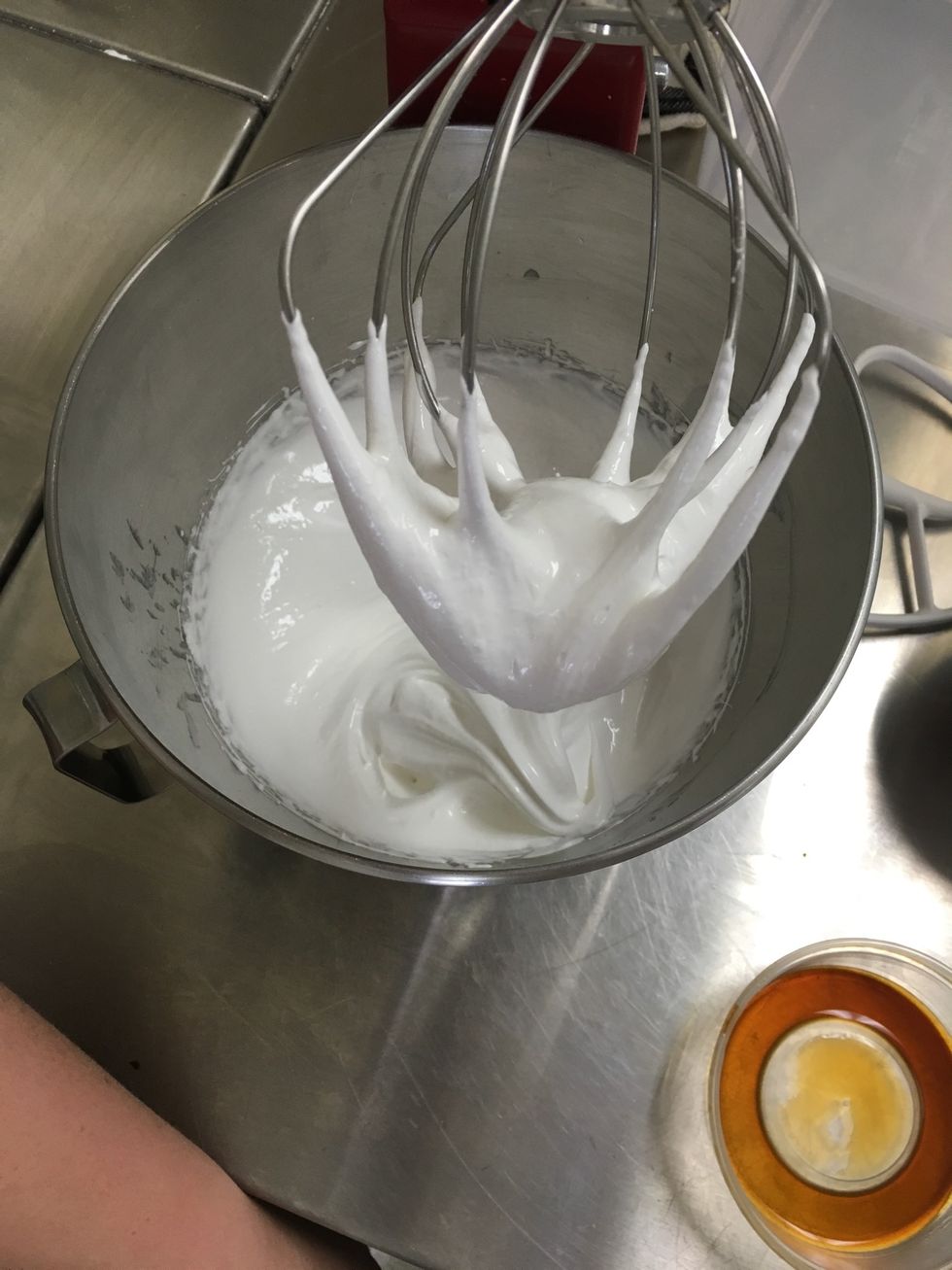 Put the egg and sugar mix in the stand mixer with the whisk attachment and whisk until it makes a firm peak.