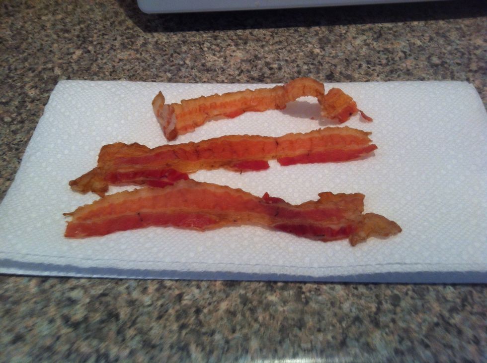 Put the egg in the microwave on high for about 1 minute. While the egg cooks prepare your bacon for the journey to the Microwave.