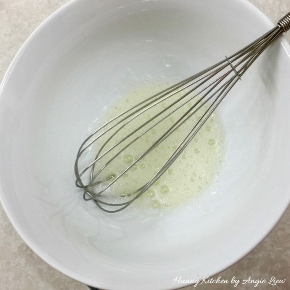 Put the egg white in a large bowl and whisk until it's nice and frothy.