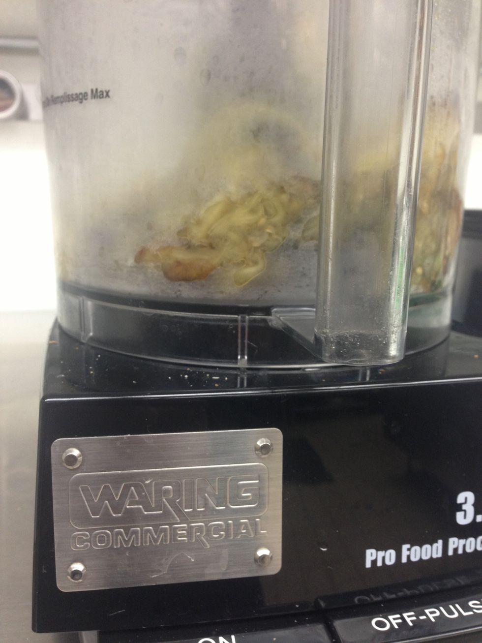 Put the eggplant and garlic into a food processor.