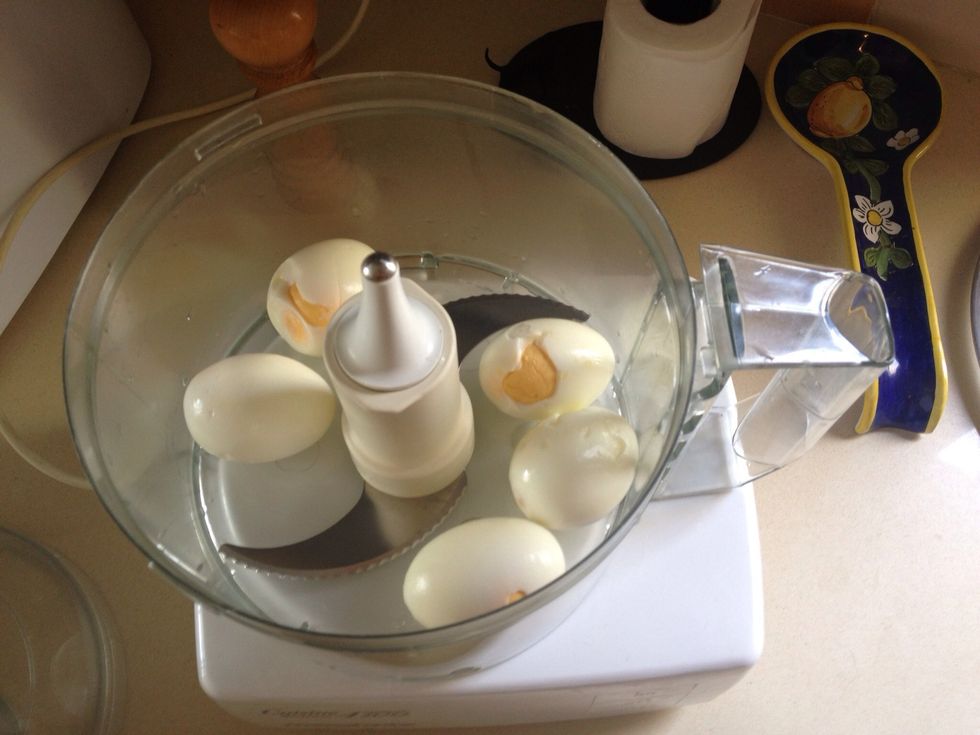 Put the eggs in a food processor. Use the steel knife.