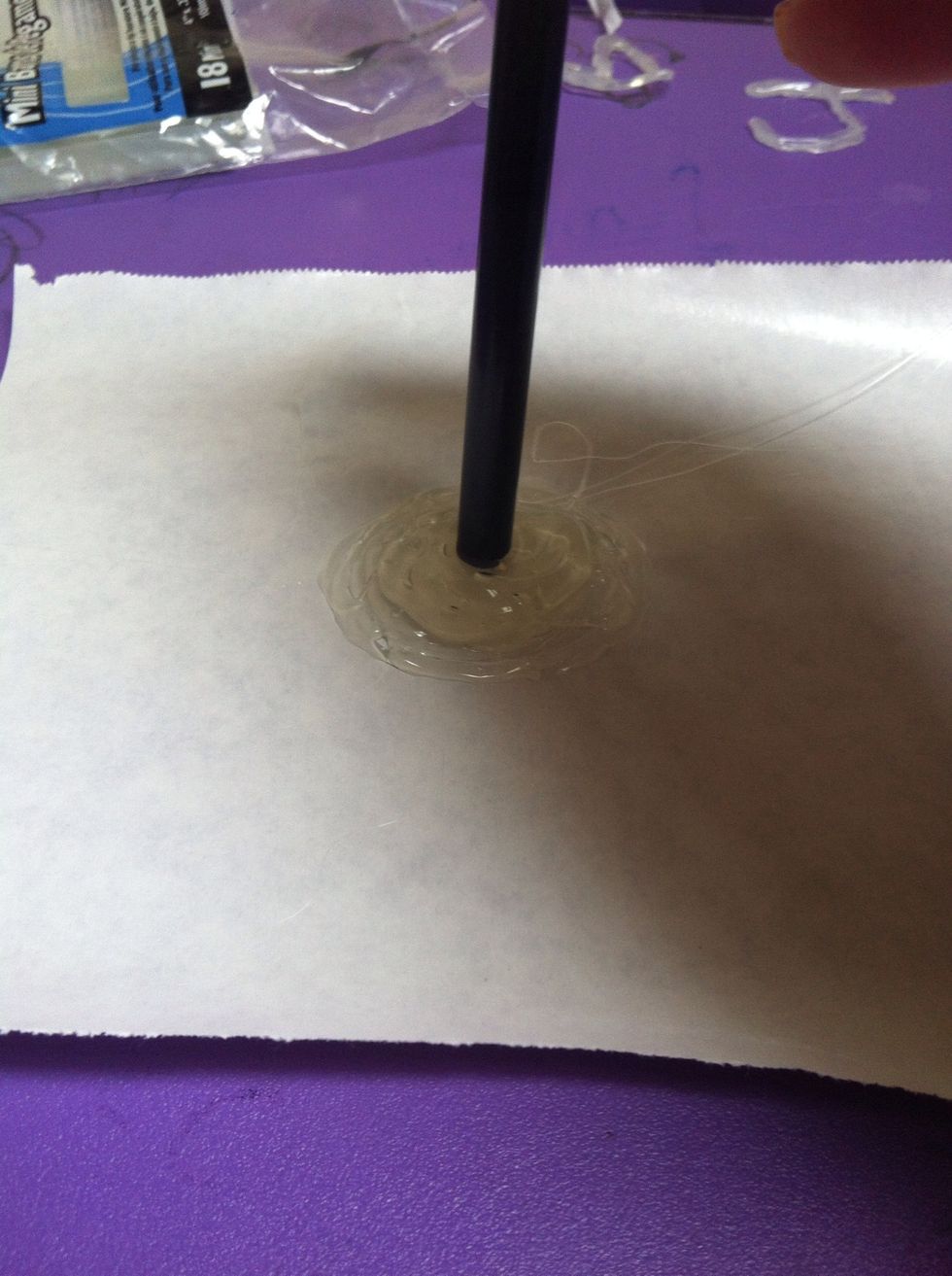 Put the end of your pencil into the glue. If you are using a normal non-colored pencil, take off the eraser and metal thingy that holds the eraser on so you just have the wooden part.