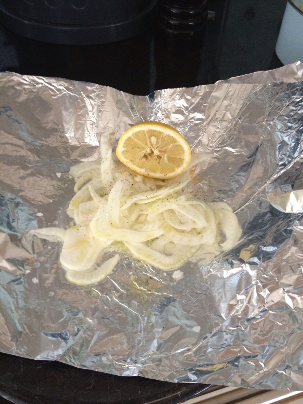 Put the fennel on the centre of the foil and squeeze some lemon over it (saving some for later). Season lightly.