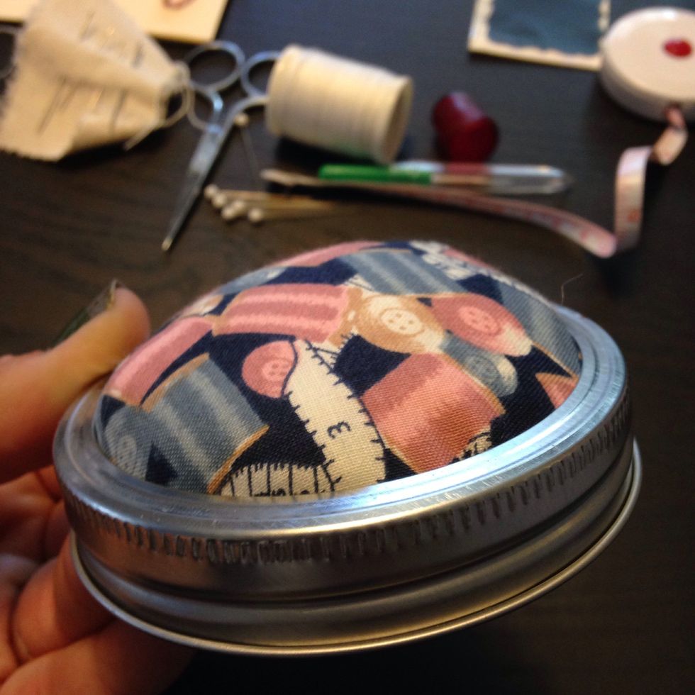Put the flat part of the lid through the ring