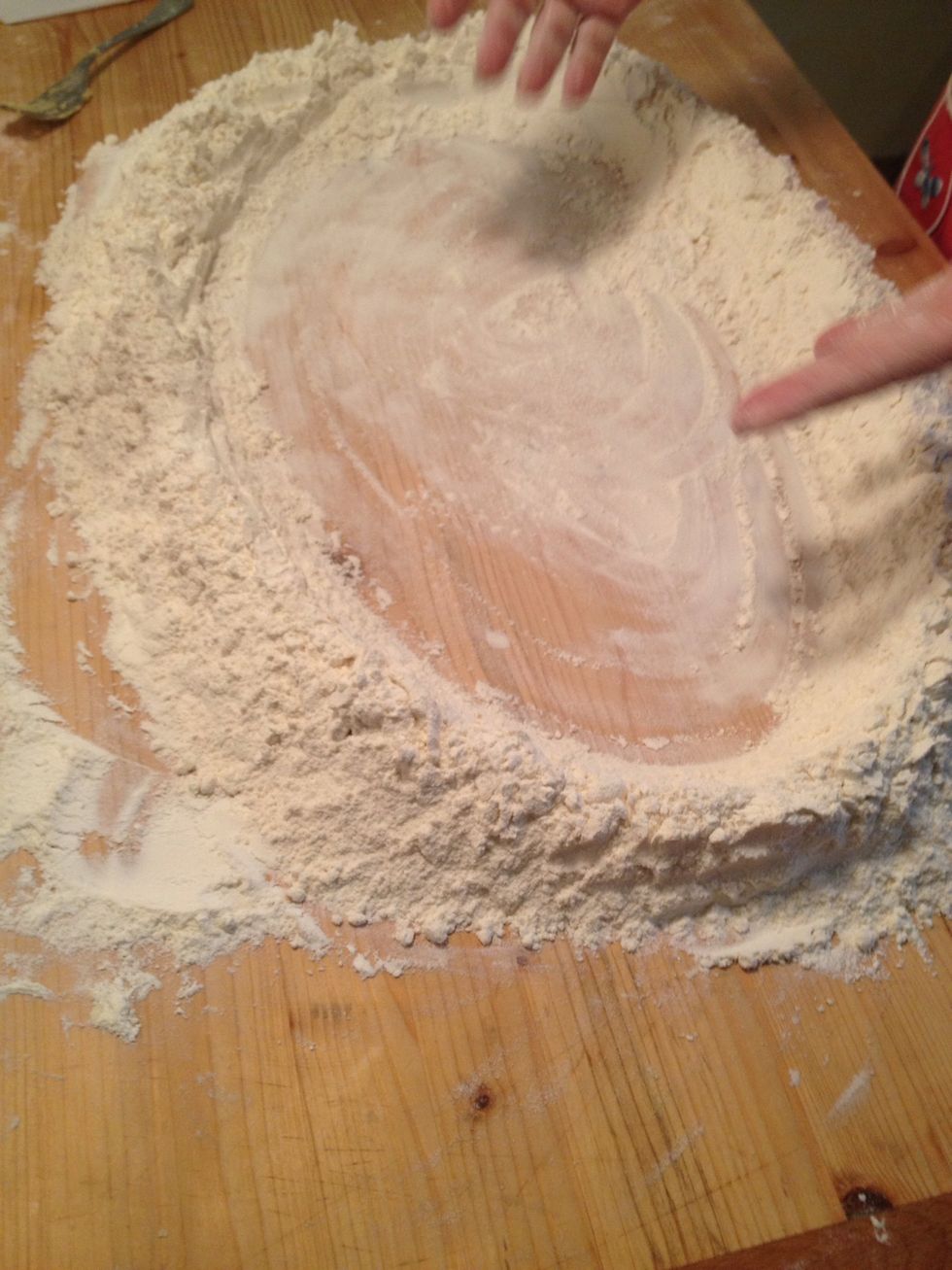 put the flour on the table and make a big hole in the middle like a dam
