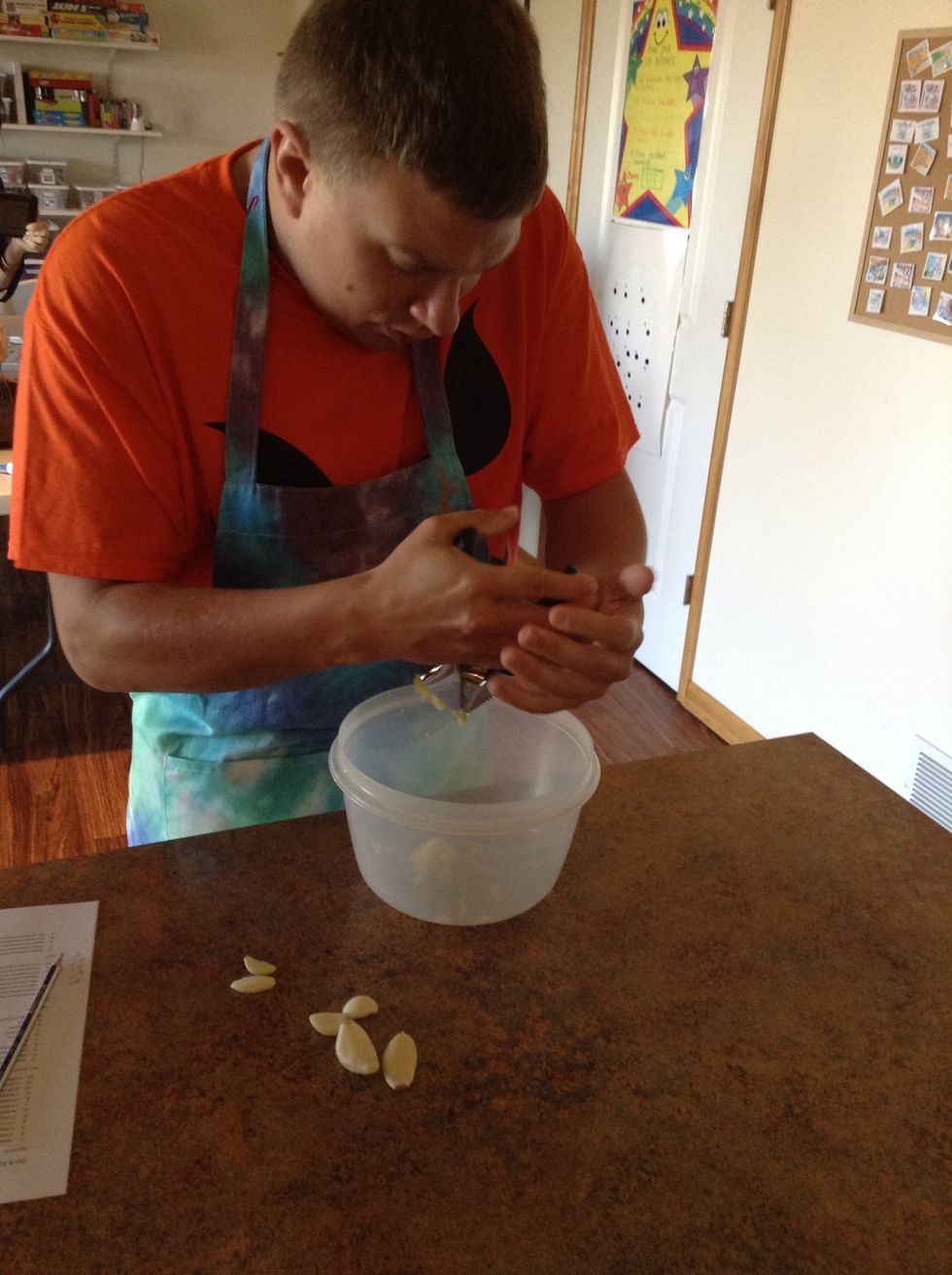 Put the garlic cloves one at a time into the garlic press chamber and squeeze the handles together.