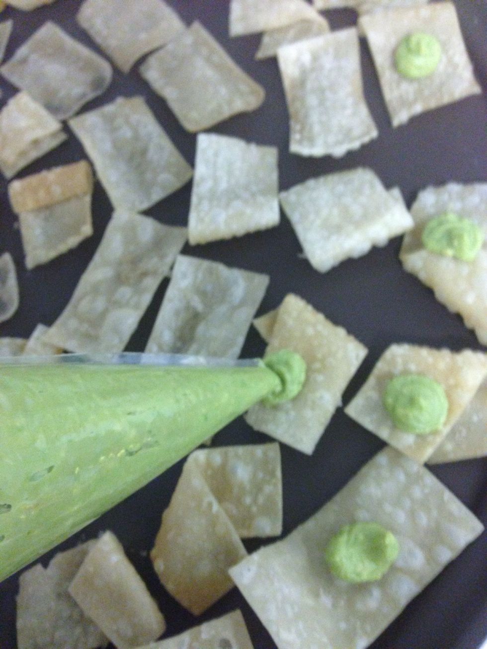 Put the guacamole on top of the won ton