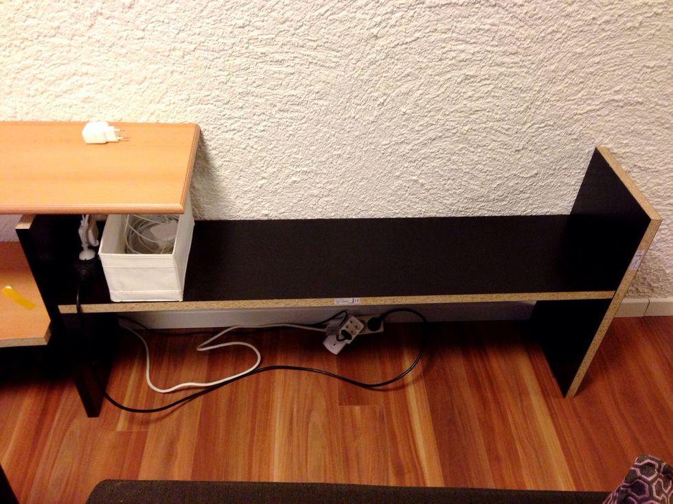 Put the H-shaped shelf in place. This is basically two short pieces of wood and a longer one in between.