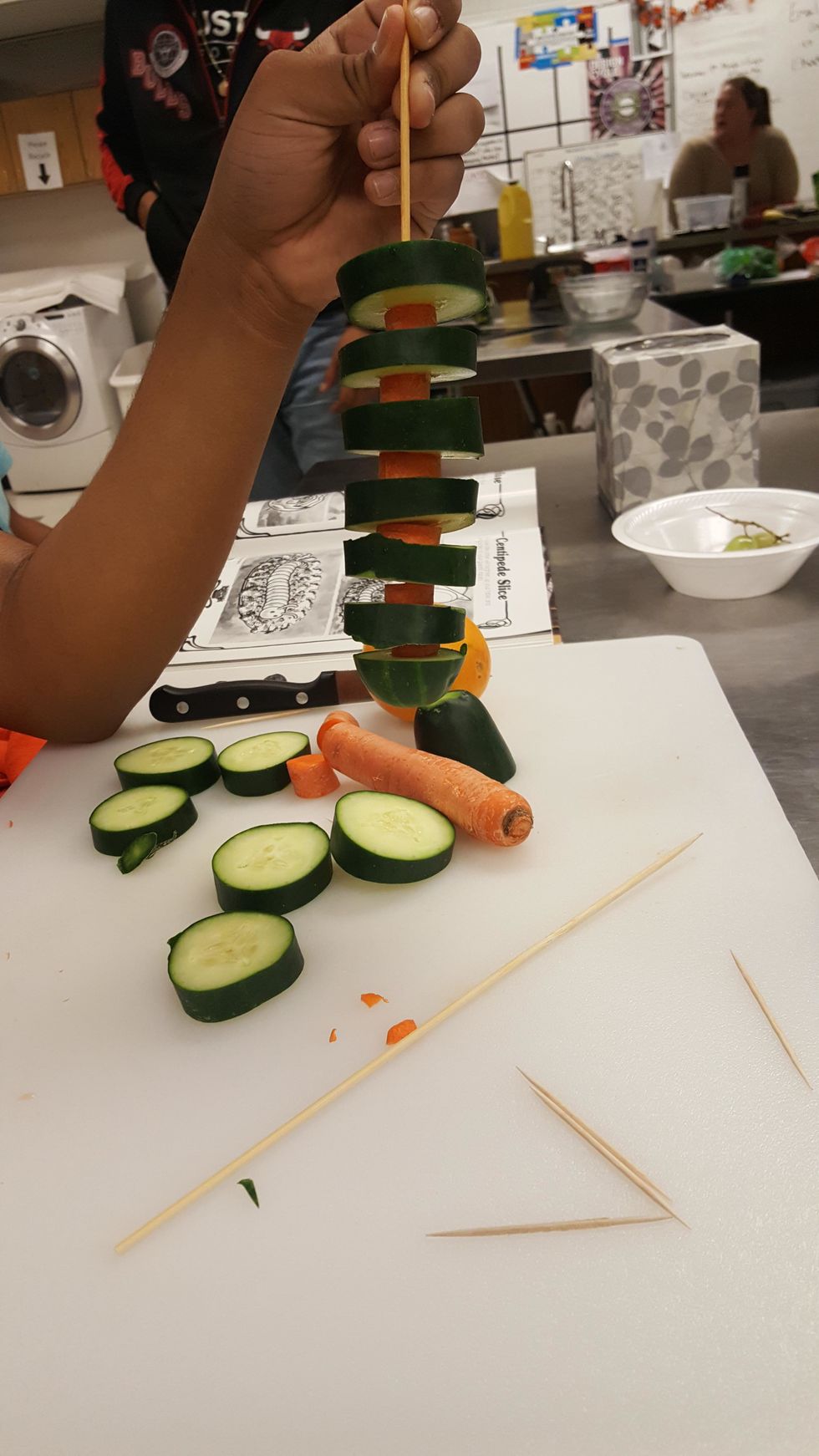 Put the half inch slices of carrot and cucumber on a skewer. Arrange them in order of a slice of cucumber and then carrot and repeat.