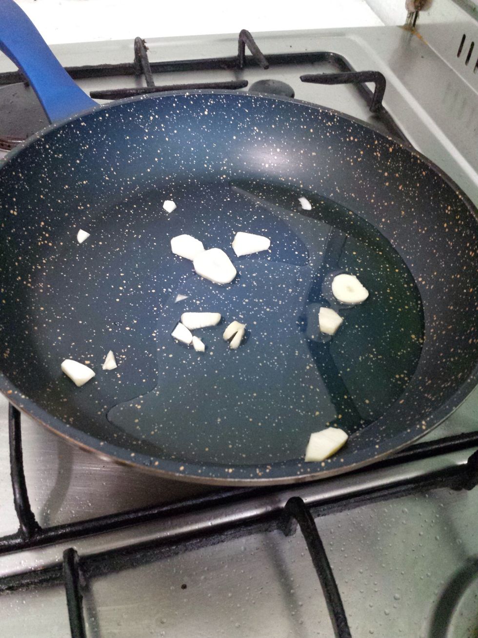 Put the heat on a medium-low and throw the garlic in the with about 25-50ml of oil.