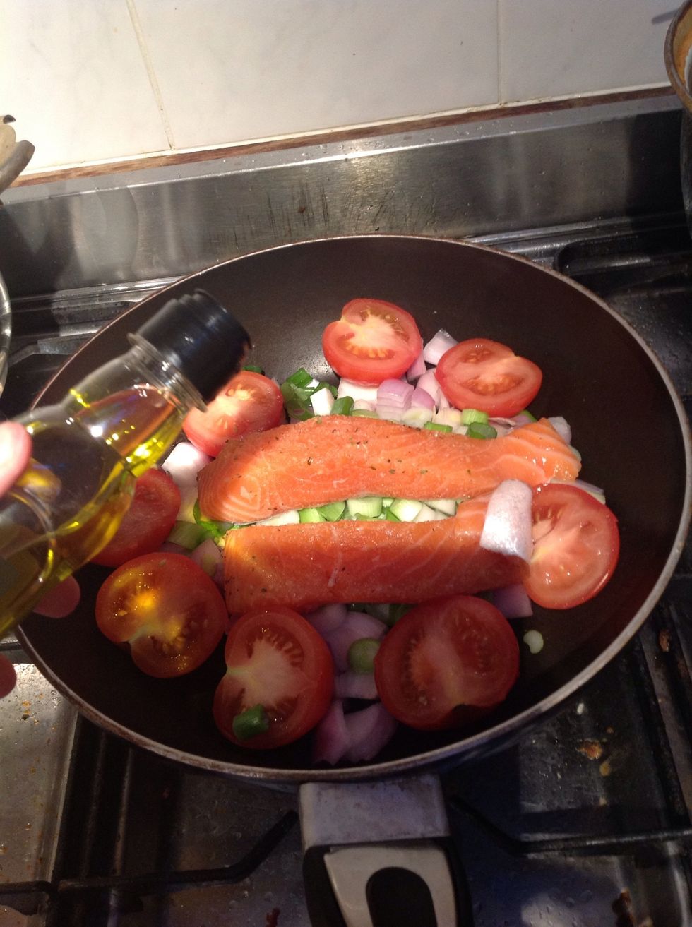 Put the heat on, put the salmon in the pan and add a little olive oil