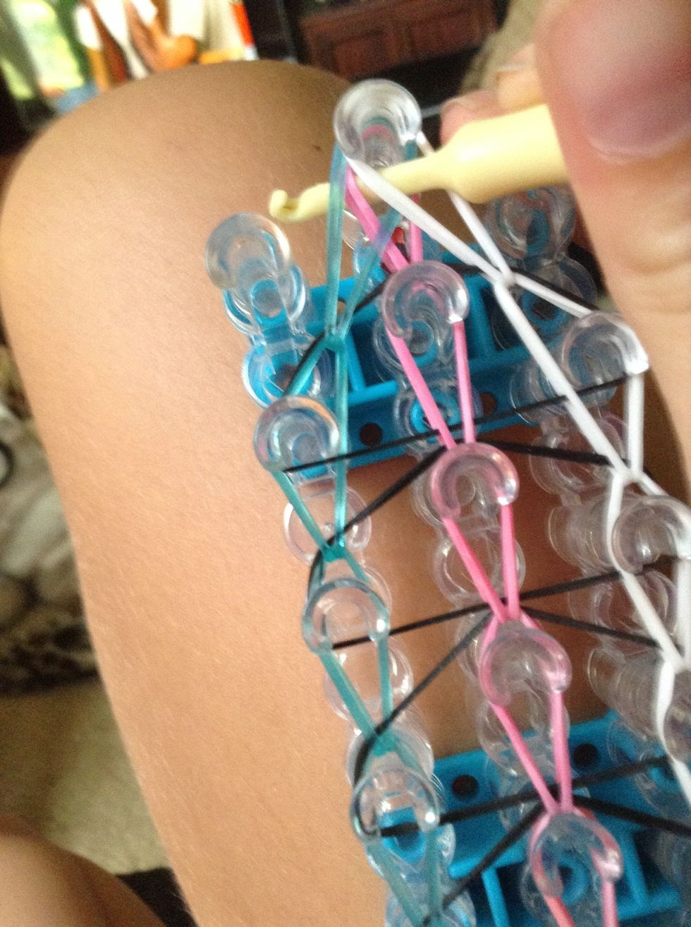 Put the hook through and under the rubber bands.