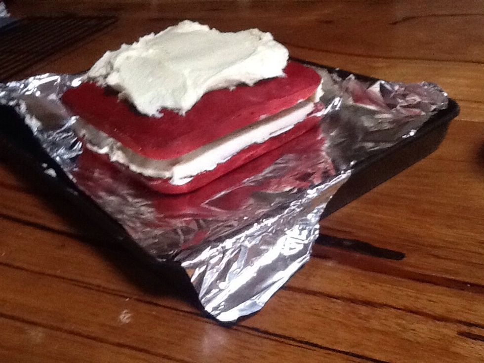 Put the icing in the middle of the two cakes then start the top