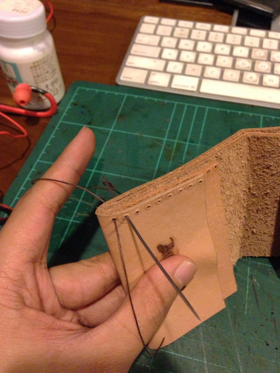 Put the inner layer and outer layer together and then by using an awl, punch a hole to sew the both layer together, sew it together using a waxed thread