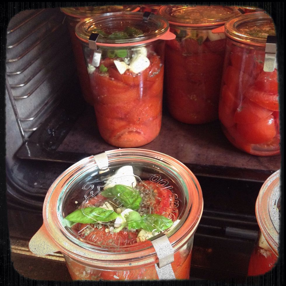 Put the jars in the oven for 2 hours at 110 C / 225 F. When boiling jars with content all bacteria are killed and the tomatoes will last for a long time in your cabinet afterwards